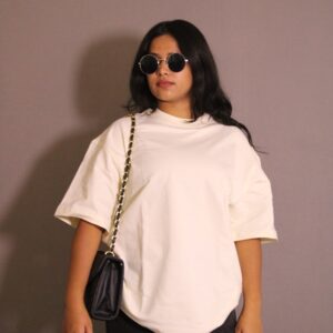 a woman wearing sunglasses and a white shirt