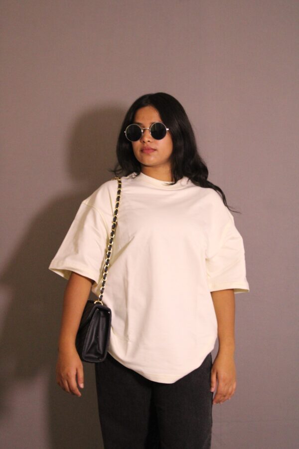 a woman wearing sunglasses and a white shirt